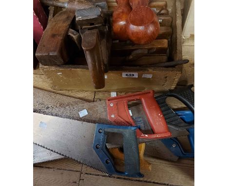 A wooden box containing planes and other woodworking tools - sold with a quantity of hand saws