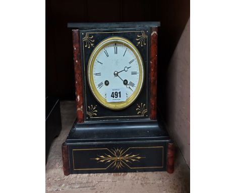 A late Victorian black slate and red marble cased mantel clock with Aesthetic incised and gilded decoration and eight day bel