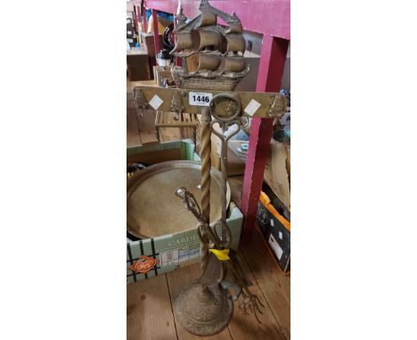 A brass companion set with ship form finial