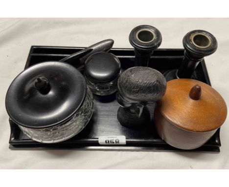 A vintage ebony and glass dressing table set comprising lidded pots and a pair of candlesticks - sold with small carved Afric