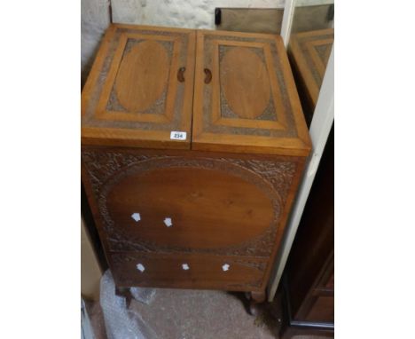 A 62cm Indian carved hardwood drinks cabinet with bi-folding top and blind drawer to base, set on cabriole legs with pad feet