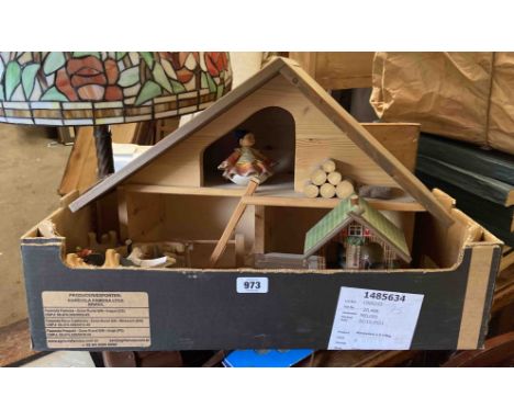 A box containing a model farmhouse with animals and other items