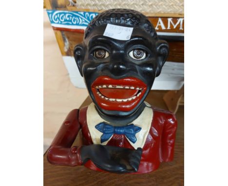 A vintage cast iron 'Jolly' pattern money box Notice from the the-saleroom.com: These items are listed on the basis they are 