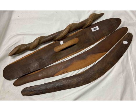 A quantity of Australian Aboriginal carved wood items consisting of two hunting boomerangs, a fighting stick with carving of 