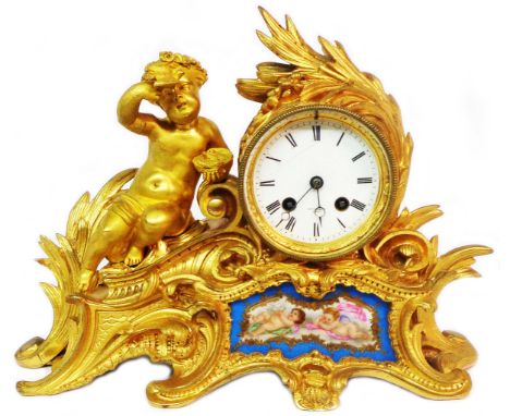 A 19th Century French ormolu salon clock with figure of a putto holding a bird seated beside the acanthus decorated drum dial