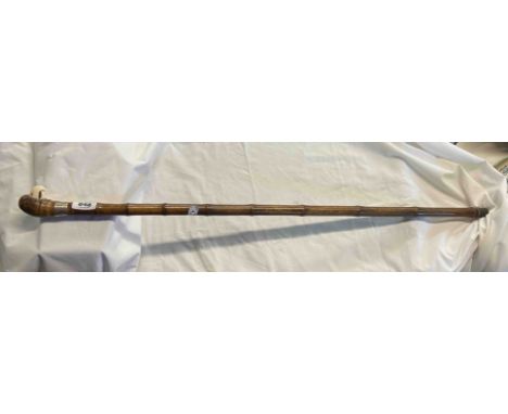 An antique bamboo walking stick with parrot handle, silver collar and ivory beak - CITES Reference D2R6DVQQ