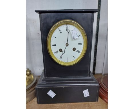 A late Victorian black slate cased mantel clock with eight day striking movement