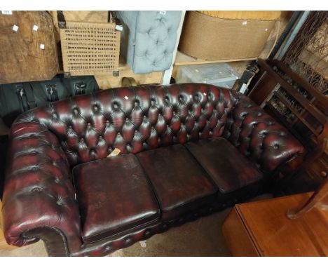 A 1.9m modern Chesterfield three seater settee with button back oxblood leather upholstery