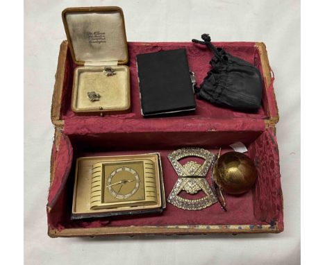 A small antique velvet covered coffer shaped jewellery box containing powder compact, enamelled travelling clock, etc.