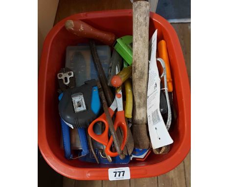 A red crate containing a quantity of tools including tape measure, hammers, etc.