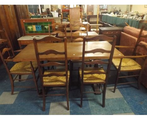 An Oak Refectory Dining Table Together with Six Rush Seated Ladder Back Chairs.