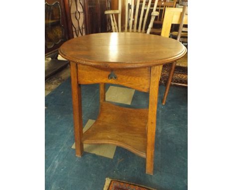 An Oak Circular Topped Occasional Table with Stretcher Shelf. 