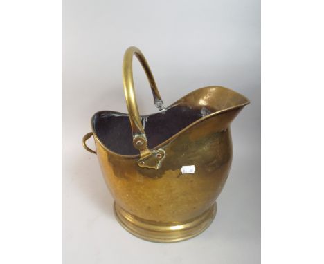 A Brass Helmet Shaped Coal Scuttle with Fire Tongs. 