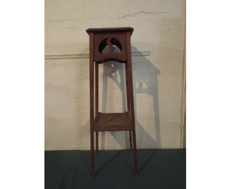 An Edwardian Oak Jardiniere Stand with Pierced Top and Stretcher Shelf.  