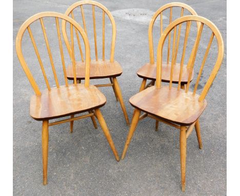 A set of four light elm Ercol stick back kitchen chairs.