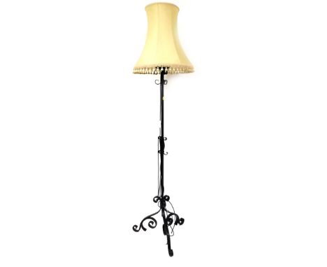 A cast iron standard lamp, on tripod base with cream shade, 170cm high without shade. 