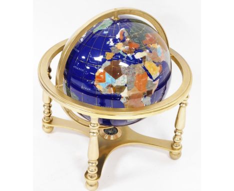 A hardstone terrestrial globe, on blue finish, on a base with compass bottom, 46cm high, 44cm diameter.