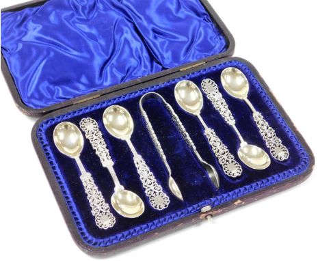 An Edward VIII Arts and Crafts silver spoon and sugar tong set, with pierced and scroll decoration, makers stamp HH, Sheffiel