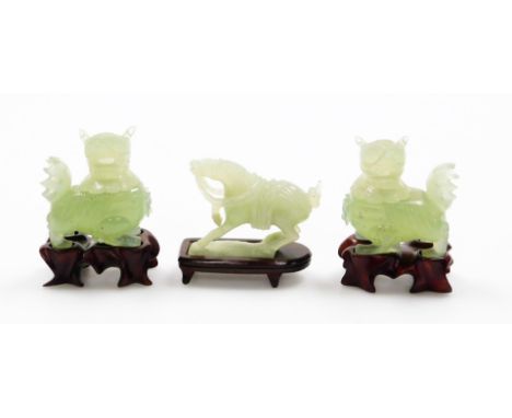 Various 20thC Chinese green jade carvings, to include a pair of dogs of fo with removable heads, probably incense burners, on