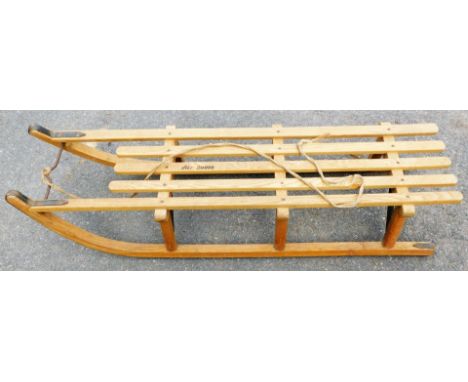 A vintage wooden sled stamped AVT DAVOS, 113cm long.