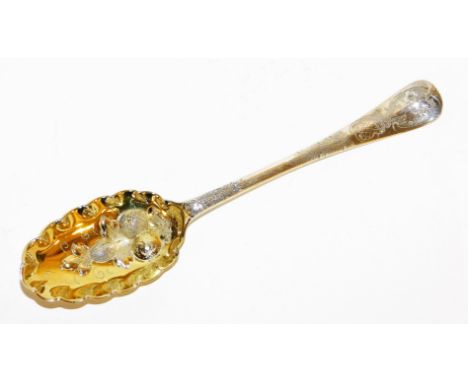 An 18thC silver berry spoon, the stem with floral leaf engraving, later embossed with three berries on a gilt finished spoon,