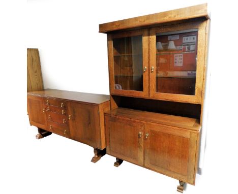 An oak dining room suite, comprising sideboard and display cabinet, the sideboard with two cupboard doors above two short and