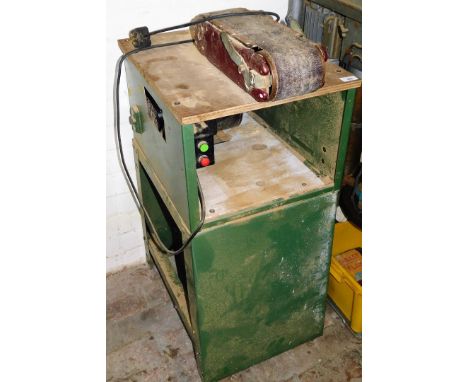 A belt sander with worktable and single phase motor. 