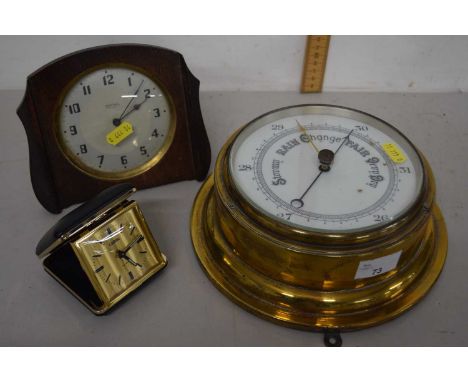A metal barometer together with a Smiths mantel clock in wooden frame and a coral alarm clock
