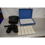 Boxed pair of binoculars together with an empty box with slots for film slides