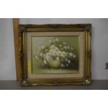 A modern picture of a vase with flowers in a gilt frame