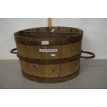 A large wooden grain measure with metal handles