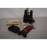 A plastic box containing a quantity of vintage binoculars including an opera example and a further