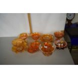 A collection of tangerine Carnival Glass