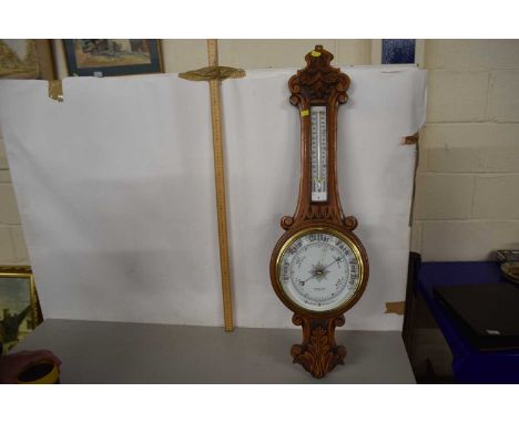 Mid 20th Century carved light oak wheel barometer retailed by Aldred &amp; Son, Yarmouth, 86cm long