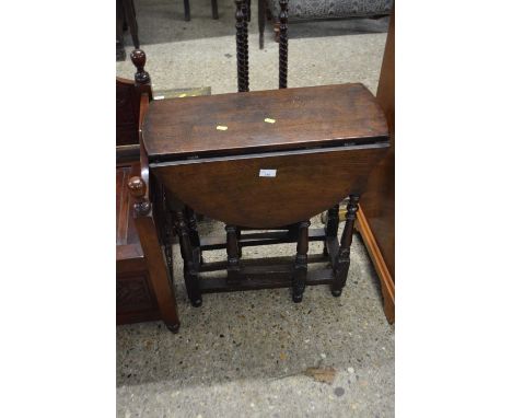An oval oak gate leg table on turned legs