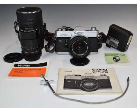 Canon FTb SLR camera with 50mm 1:1.8 lens, further Vivitar 135mm 1:2.8 lens, flash gun, manual etc