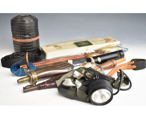 A collection of gun and shooting accessories including a copper and brass powder flask, a leather shot flask, two cleaning ki