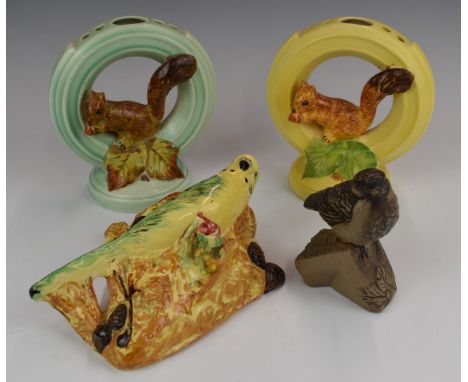 Two Burleigh Ware squirrel flower frogs, budgie wall pocket and a Poole pottery bird, tallest 20cm