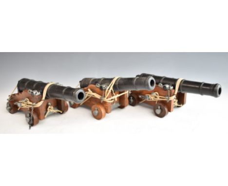 Three model cannon with wooden carriages and pulley and rope system, length 27.5cm