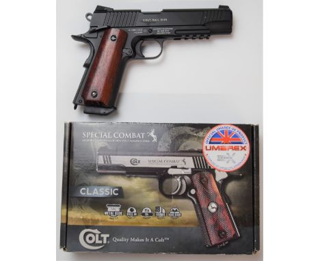 Umarex Colt 45 Government Model Special Combat .177 airsoft pistol with wooden grips, serial number 14E29388, in original box
