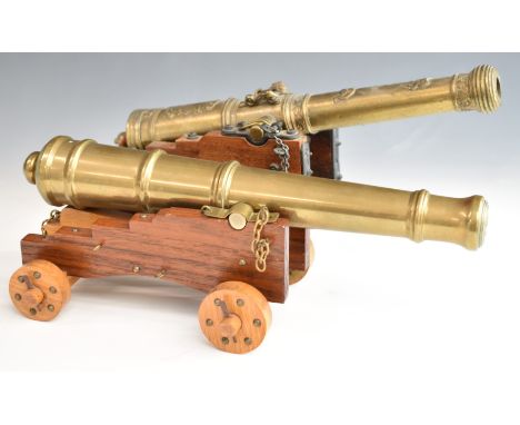 Two model cannon with brass or similar barrels and wooden carriages, one marked El Tigre 1797, length of longer 34cm