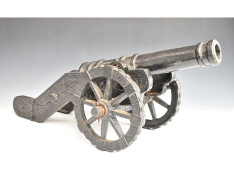 Cast iron model cannon with coat of arms to barrel, overall length 72cm