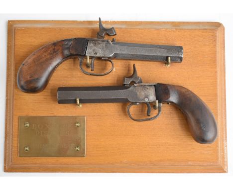 A pair of percussion hammer action pocket pistols each with shaped wooden grips and 3 inch smooth bored octagonal barrel, ove