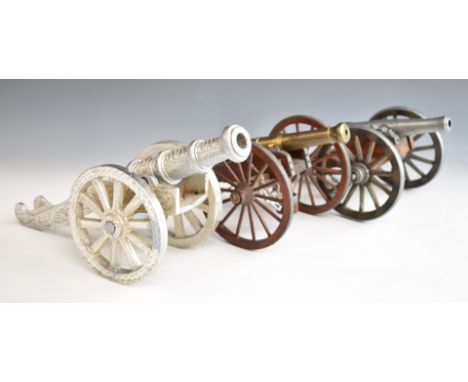 Three model cannon including one with wooden wheels and bucket below, another marked Dahlgren 1861, length of longest 32.5cm