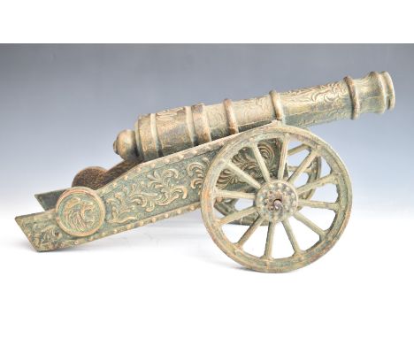 Bronze or similar model cannon with lion mask to front, overall length 61.5cm