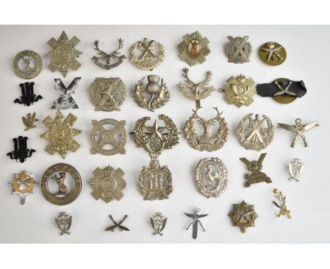 Approximately thirty Scottish and Gurkha metal hat badges including Cameron's, Black Watch, Liverpool Scottish, Highland Ligh
