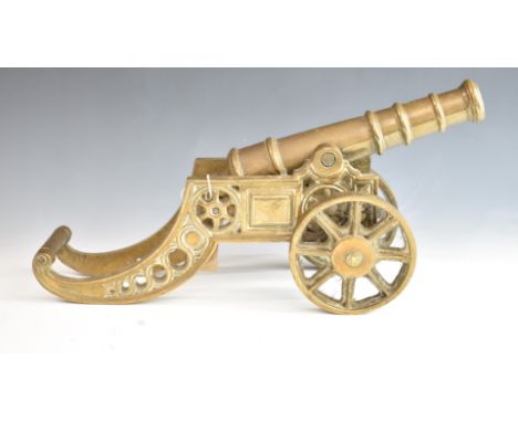 A model desk or signalling cannon with 11 inch graduated brass barrel on brass carriage, overall length 48cm