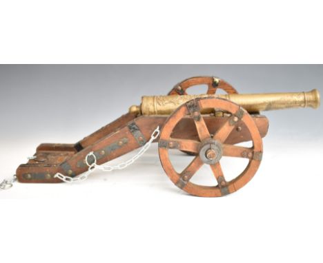 Model cannon with brass or similar barrel and wooden carriage, with plaque to rear suggesting it to be a model of a 17thC Spa