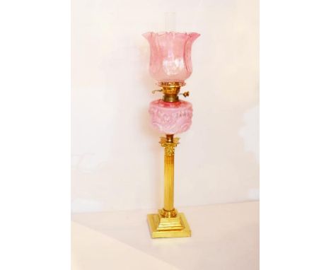A Corinthian Pillar Based Oil Lamp, Embossed Pink Bowl and Ruby Shade