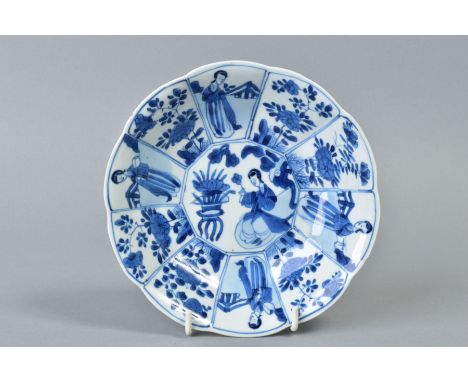 A CHINESE KANGXI BLUE AND WHITE PORCELAIN BOWL, of ten petal outline, decorated with female attendants and chrysanthemum spra